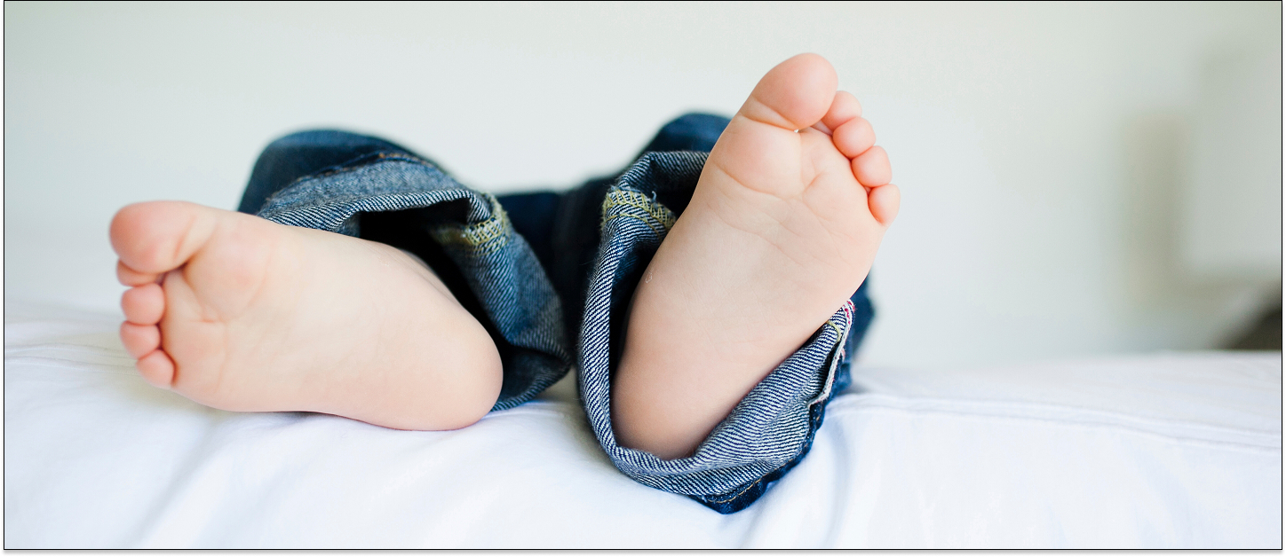 Baby feet in jeans