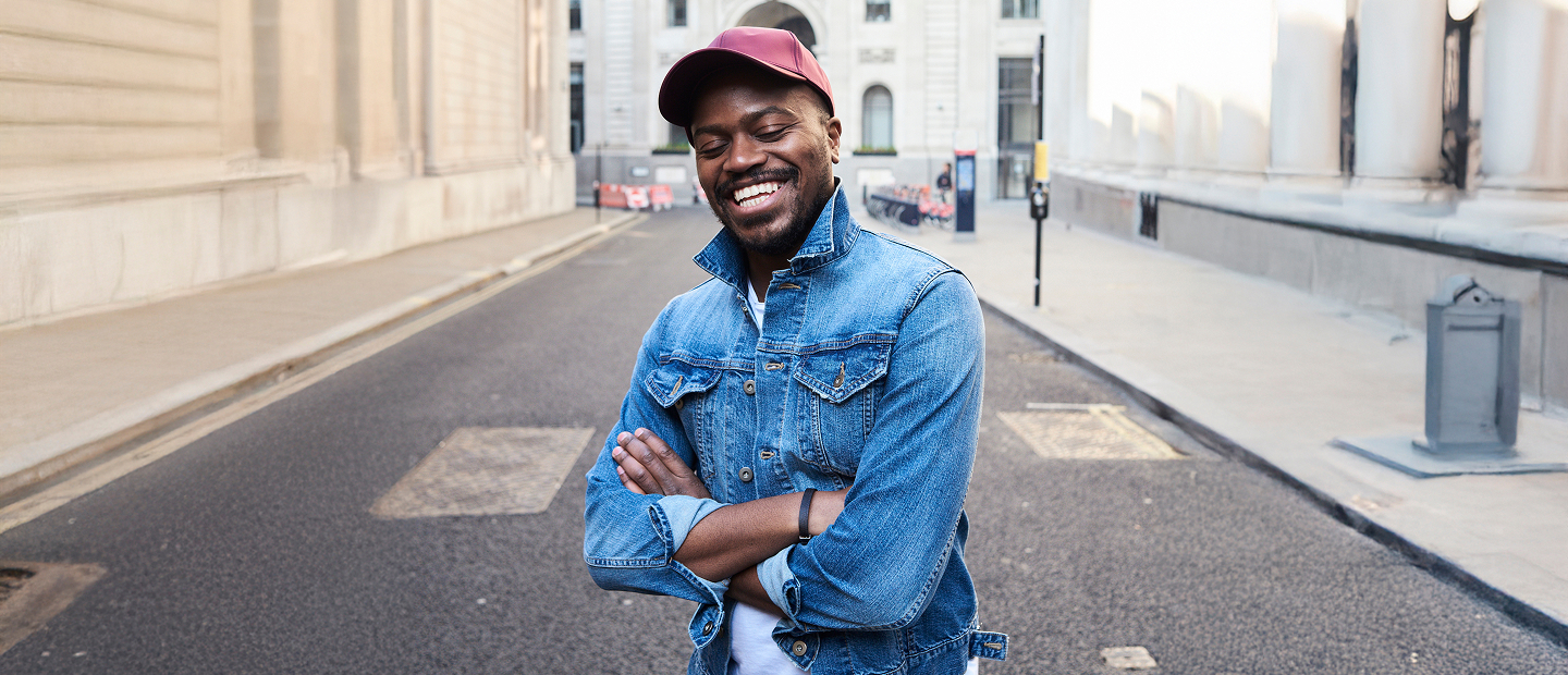 Smiling man in denim jacket