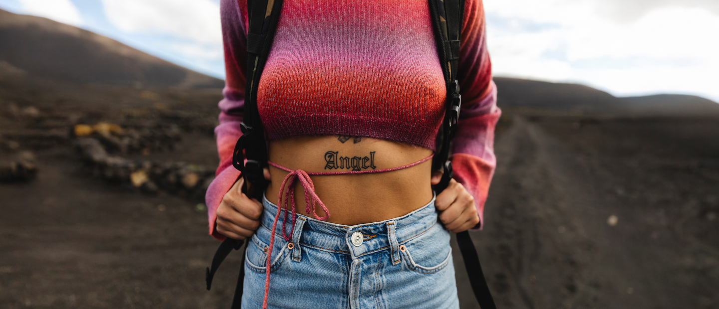 Angel tattoo, denim jeans close-up