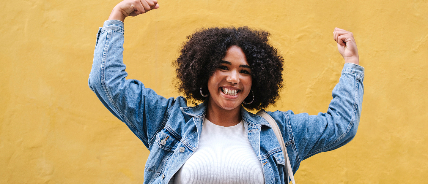 Happy woman flexing in denim