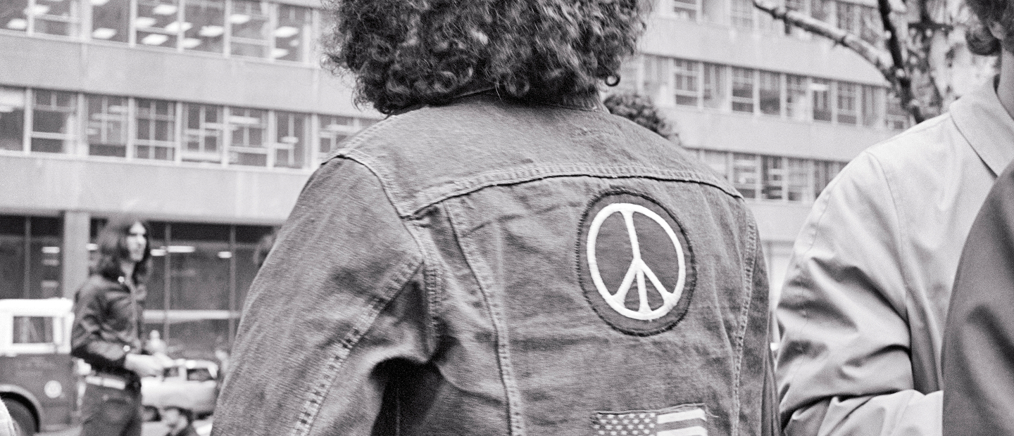 Peace sign patch on denim jacket